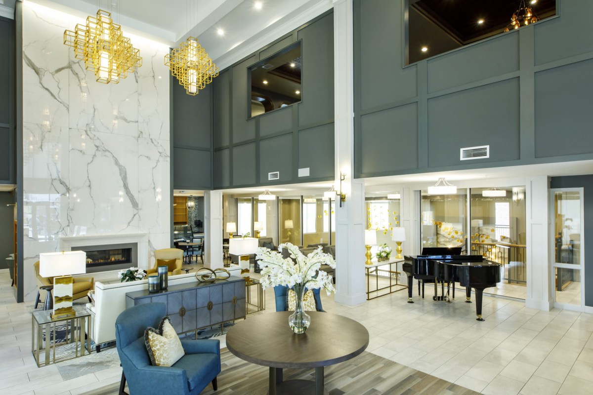 A luxurious and modern lobby interior featuring elegant chandeliers and a grand piano.