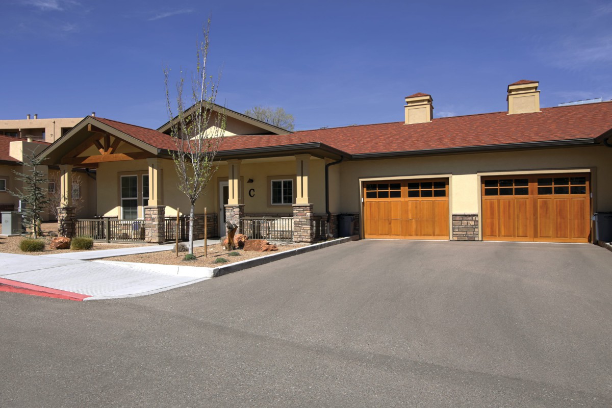 A suburban house with a spacious driveway and attached garage.