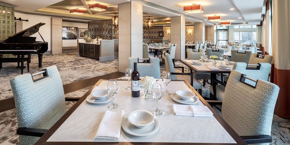 An elegantly set dining table in a modern, empty restaurant.