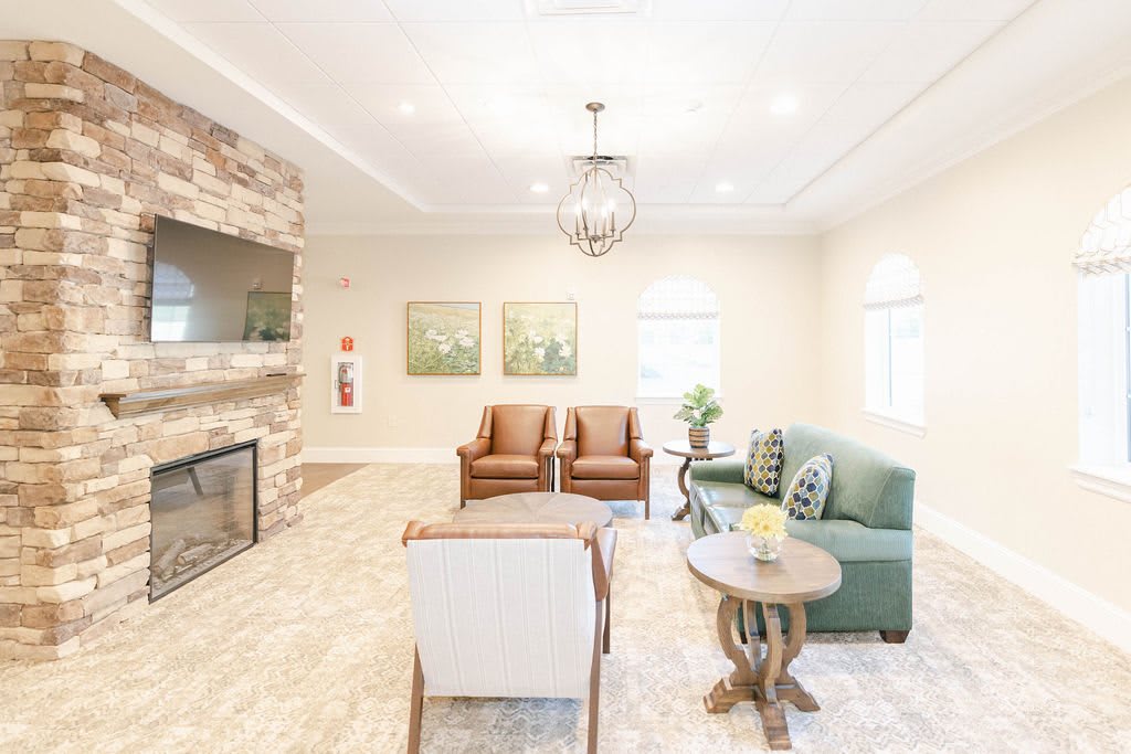 A modern and cozy living room featuring comfortable seating, a fireplace, and tasteful decor.