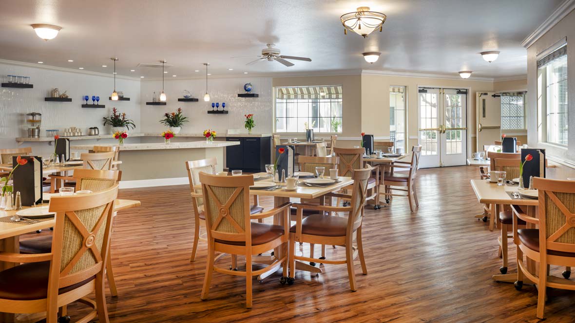 A modern dining area with wooden furniture and stylish lighting.