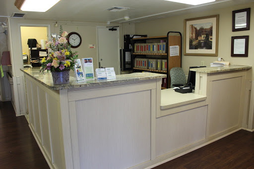 A welcoming reception area with flowers and organized files.