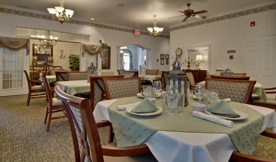 Elegant restaurant dining room with neatly set tables and classic decor.