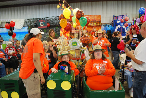 Participants enjoying a vibrant community event with colorful decorations and festive costumes.