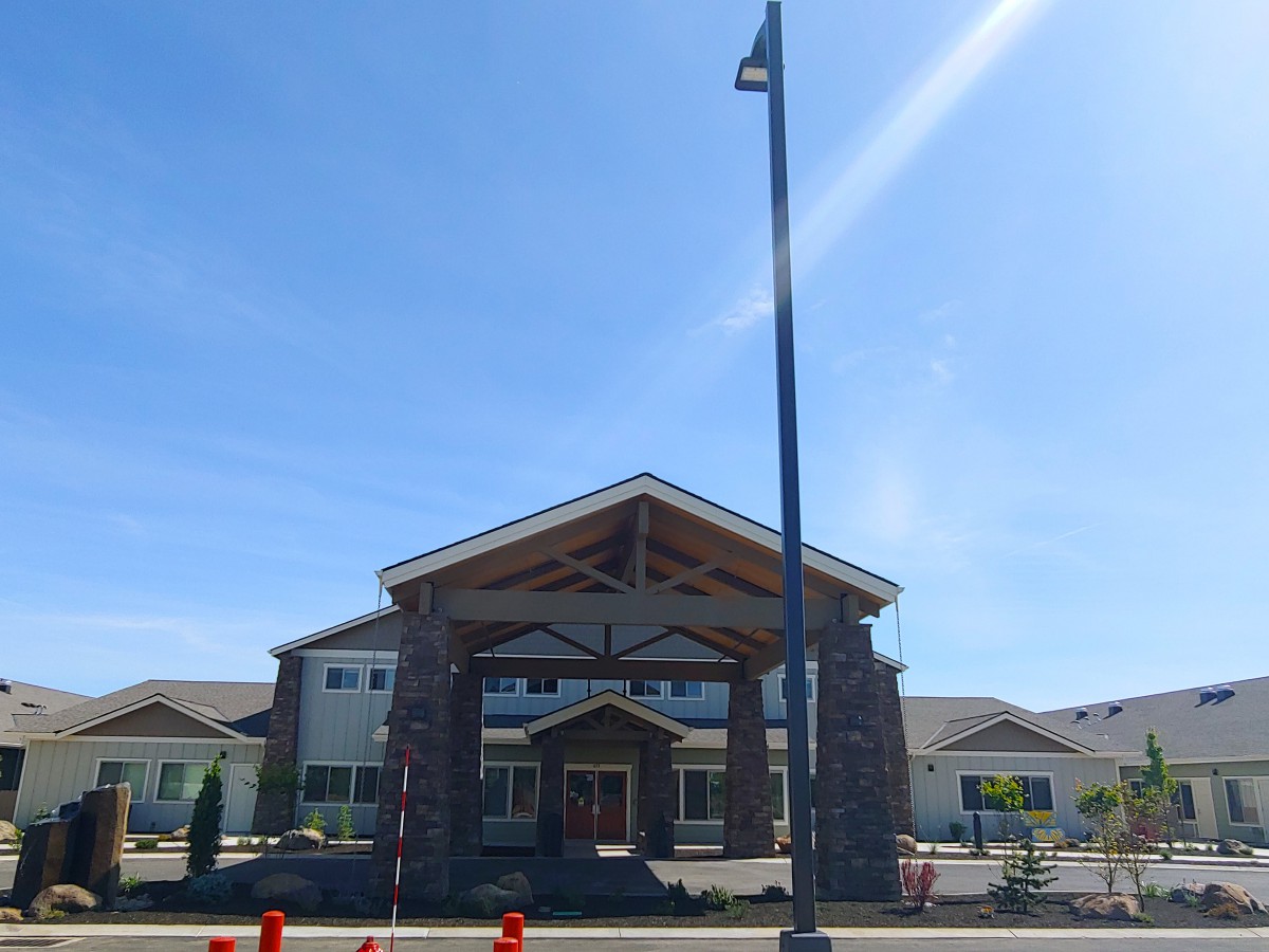 A large building with a prominent entrance under a clear blue sky.