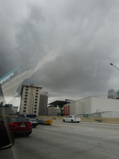 A view of a city under an overcast sky, with gray clouds looming above.