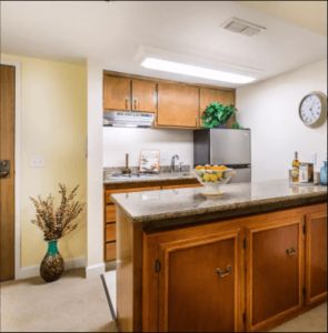 A cozy kitchen with wooden cabinets and a central island.