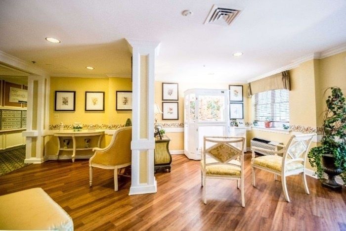 A bright and inviting dining room with elegant furniture and large windows.