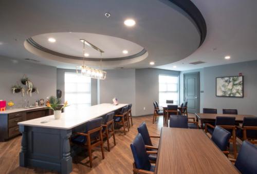 A modern dining area featuring elegant lighting and contemporary furniture.