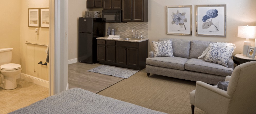 Cozy kitchenette area with a sofa and modern appliances.