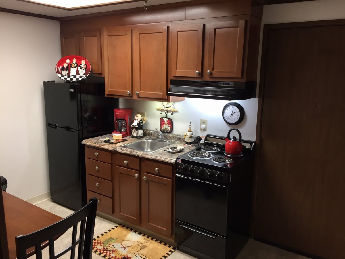 A cozy kitchen with wooden cabinets and modern appliances.