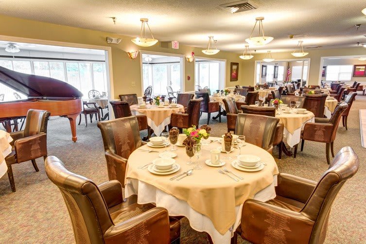 A beautifully arranged dining area with elegantly set tables and comfortable seating.