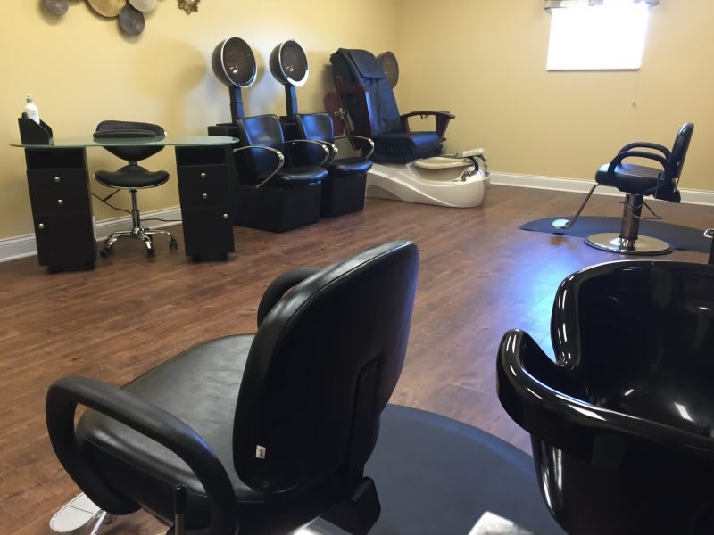 Empty hair salon with chairs and hair dryers.