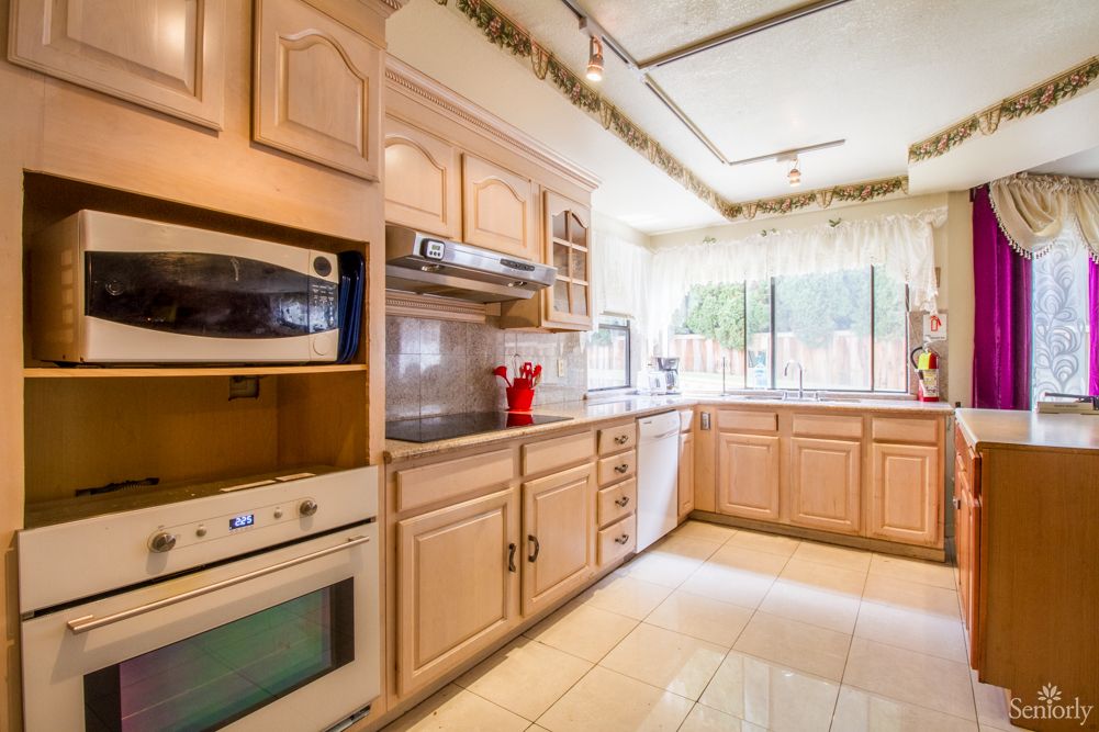 A bright kitchen with wooden cabinetry and modern appliances.