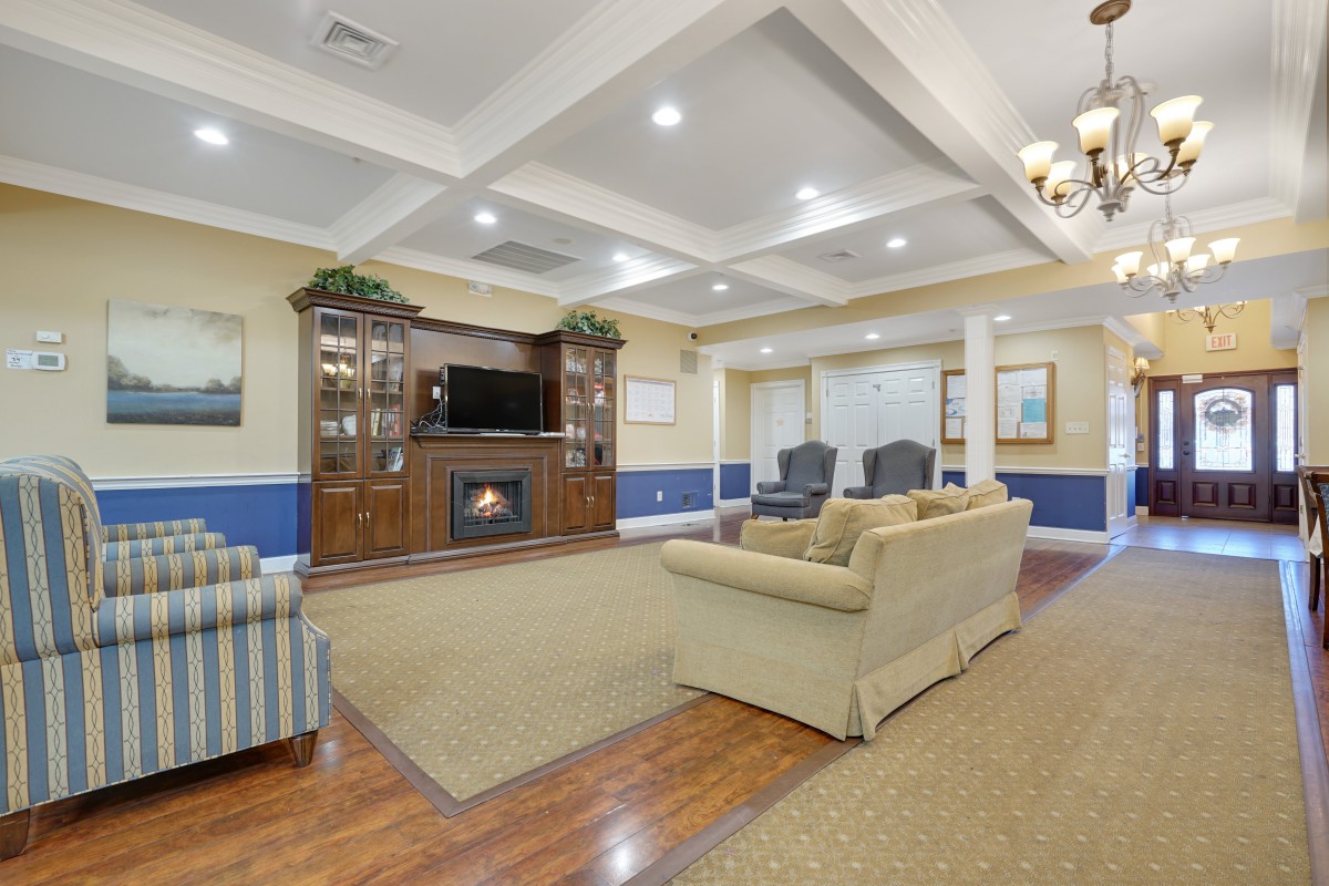 A cozy living room with a fireplace, television, and comfortable seating arrangement.