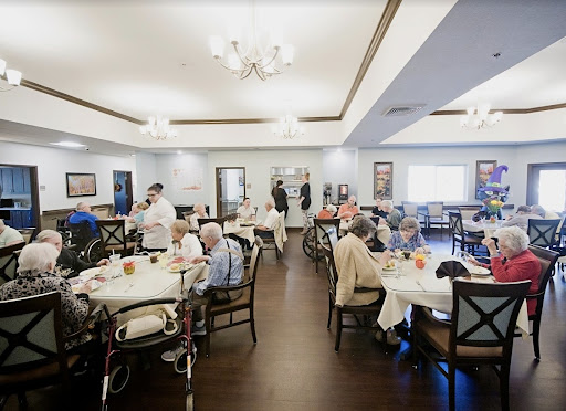Residents enjoy a meal together in a communal dining area.