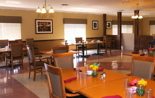A cozy dining area with wooden tables and comfortable chairs, designed for casual meals.