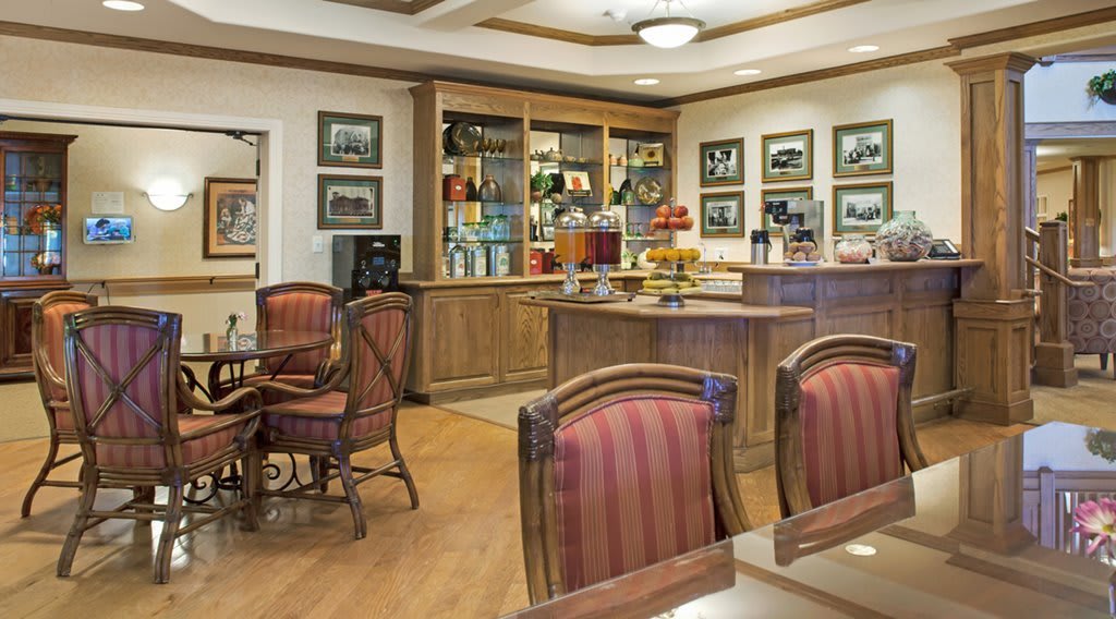 A cozy cafe interior with wooden furniture and warm lighting.
