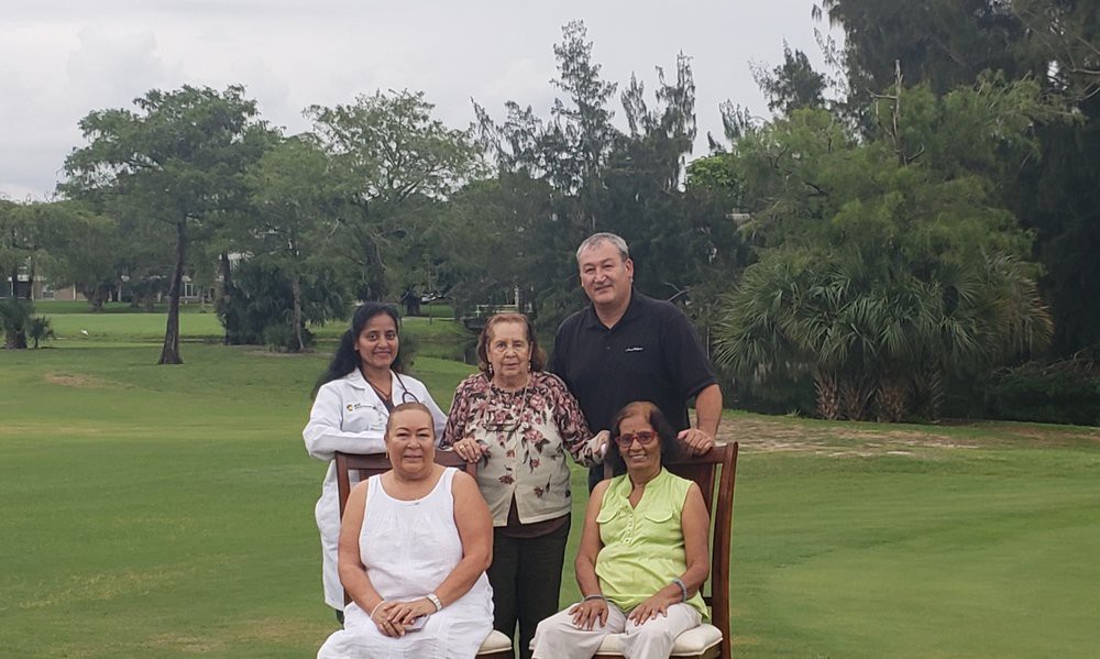 A family group photo taken on a golf course.