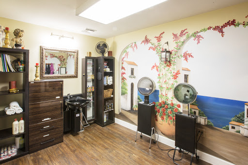 A cozy and inviting salon interior featuring a decorative mural and organized furniture.