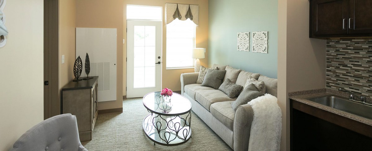 A cozy living room with a comfortable sofa, stylish coffee table, and bright natural light.