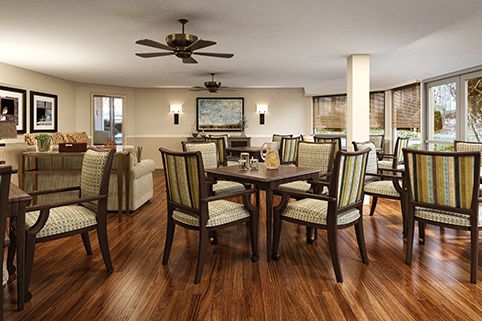 Elegant dining area with wooden floors and modern furnishings.