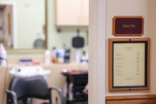 Interior view of a barbershop with a focus on the entrance signage.