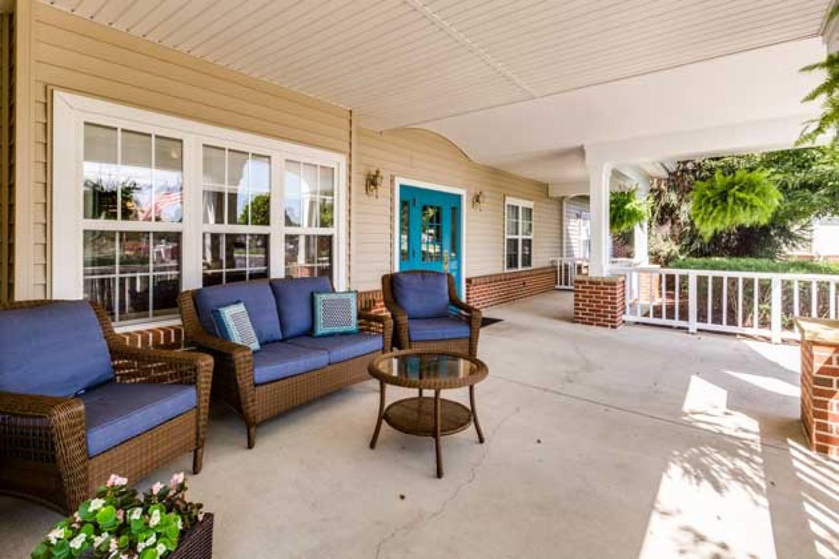 A cozy porch with comfortable outdoor furniture and a welcoming entrance.