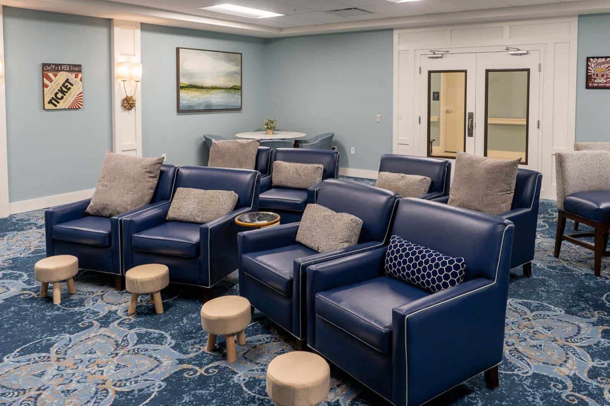 A modern lounge with blue armchairs and subtle interior decor.