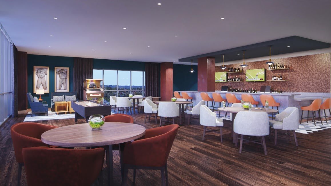A modern restaurant interior with a dining area and bar.