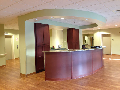 A modern reception area with wooden furniture and a well-lit ambiance.