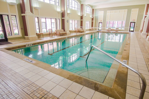 A serene indoor swimming pool bathed in natural light, perfect for relaxation and leisure.