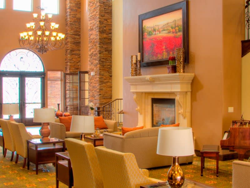 A luxurious living room interior featuring a fireplace, comfortable seating, and elegant decor.