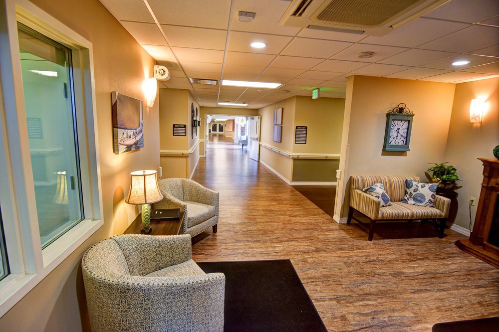A warmly lit hallway with comfortable seating and decorative accents.