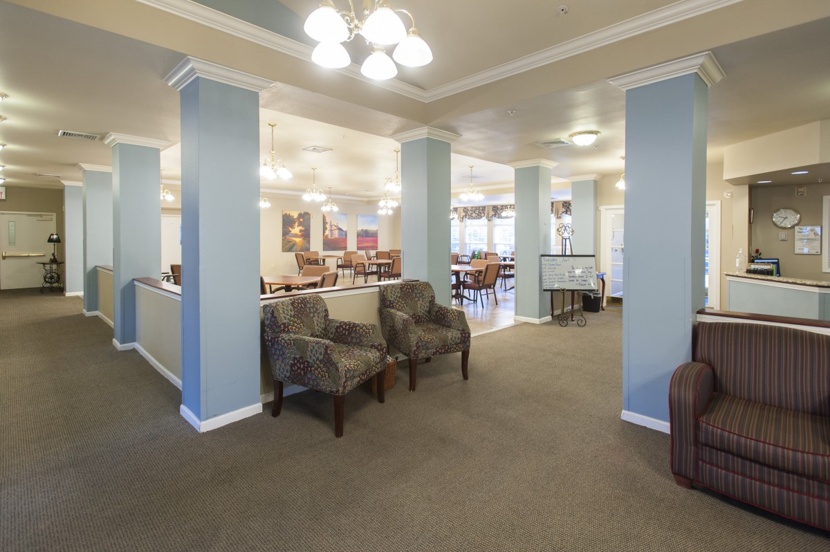 A spacious and well-lit lobby with comfortable seating and elegant pillars.