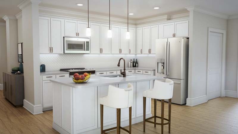A modern kitchen with white cabinetry, featuring a central island and sleek appliances.