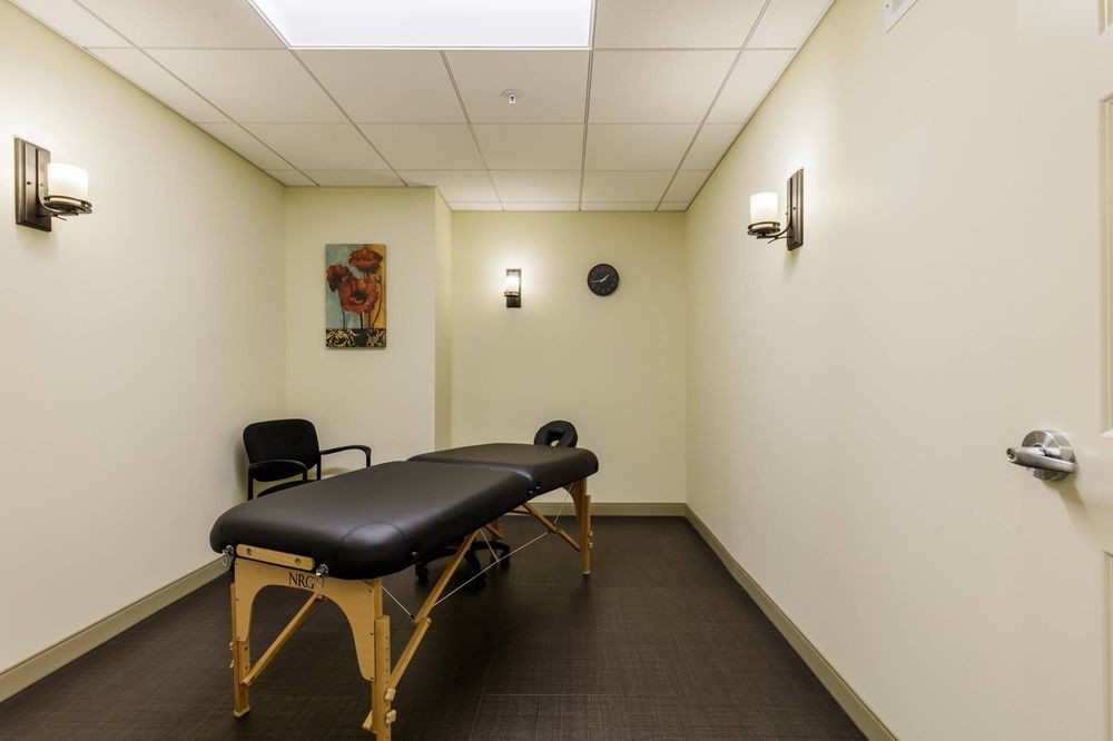 A serene massage room with a comfortable therapy table and calming decor.