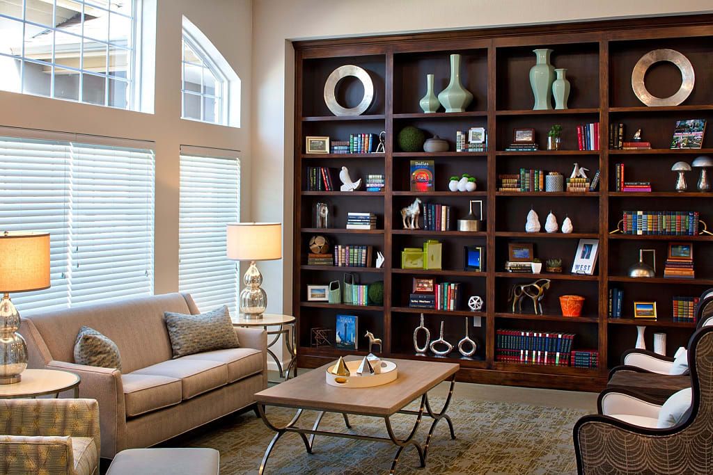 A cozy living room with a large bookshelf, comfortable sofa, and elegant coffee table.