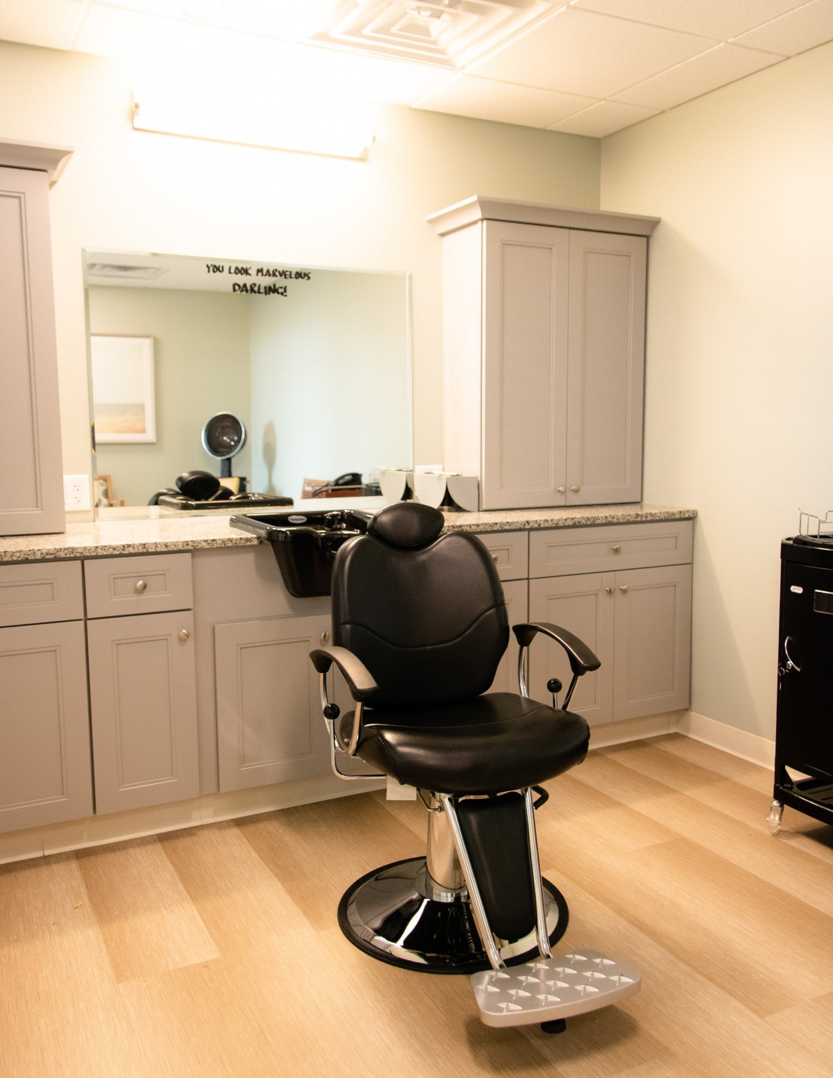A modern salon featuring a barber chair and grooming station.