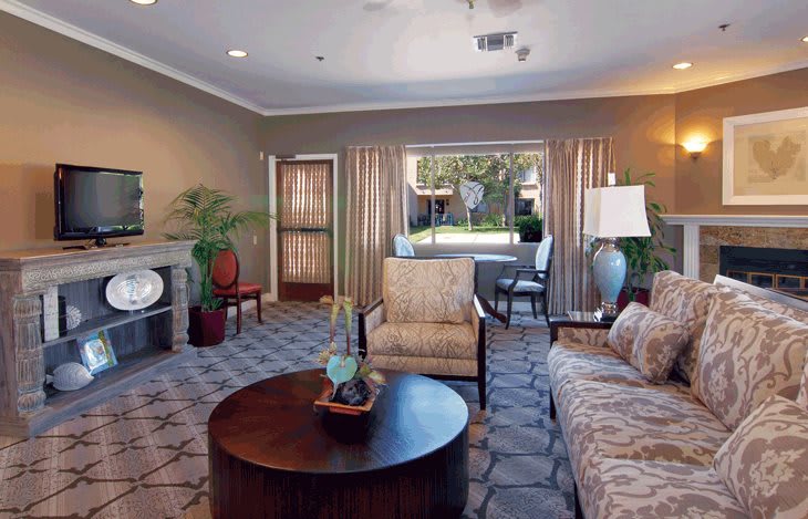 A well-furnished living room with a cozy seating arrangement and elegant decor.