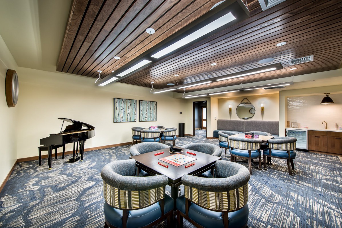 Modern lounge with a piano and comfortable seating arrangement.