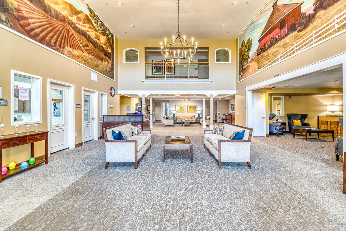 Spacious lobby with elegant chandeliers and comfortable seating.