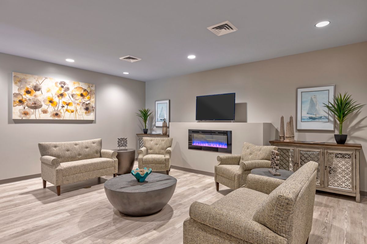 A modern living room with sleek furniture, a fireplace, and contemporary artwork.