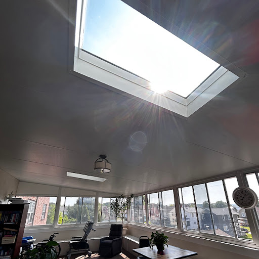 A bright and airy workspace featuring a skylight that floods the room with natural light.