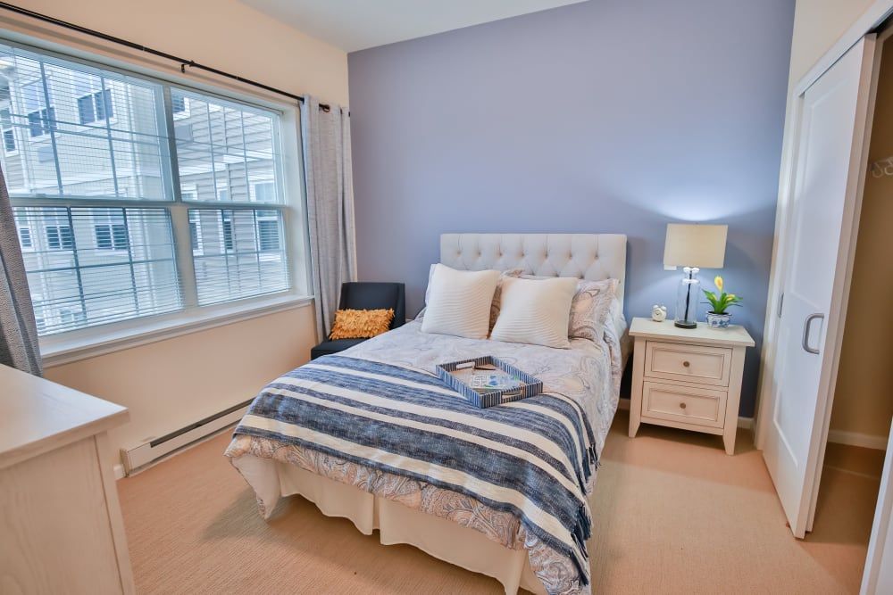 Cozy bedroom with a neatly made bed and soft lighting.