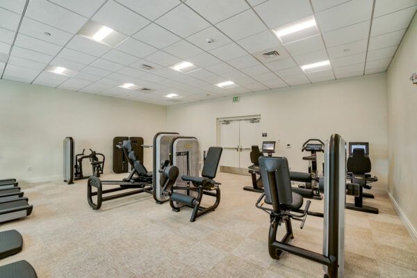 A spacious gym with various fitness machines and equipment.