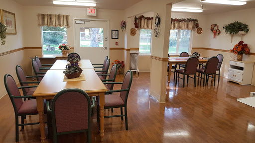 A cozy dining area featuring tables and chairs, designed for social gatherings.