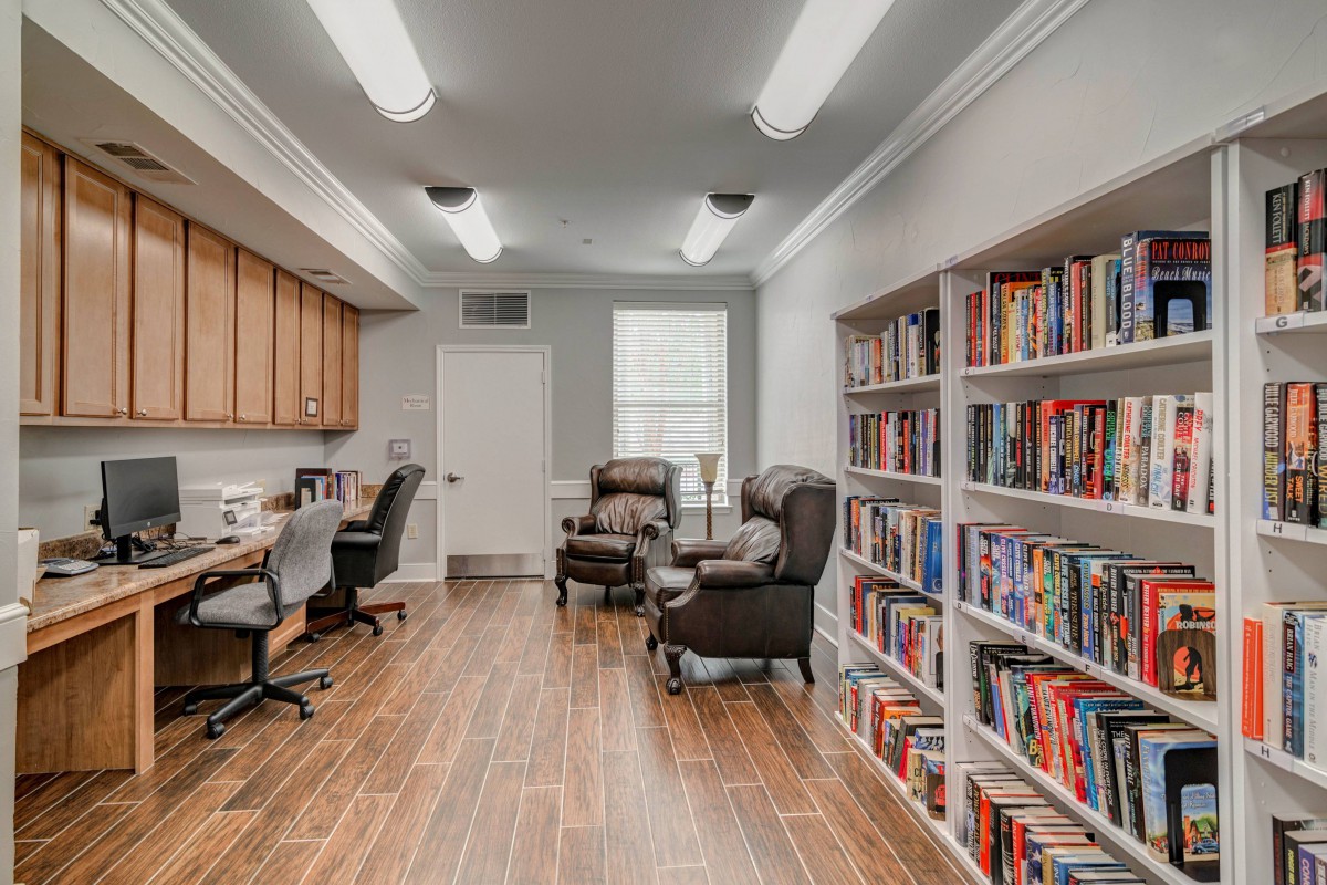 A cozy library with bookshelves and comfortable seating.