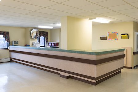 A hospital reception area with a large desk and clean, bright surroundings.