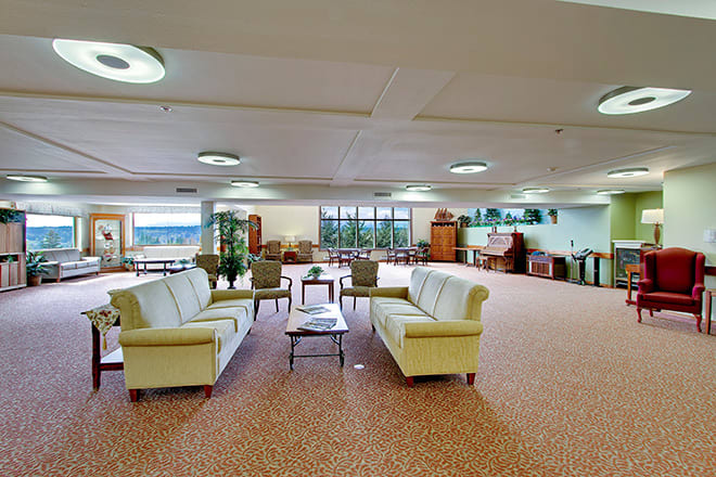 A spacious lobby with comfortable seating arrangements and large windows.